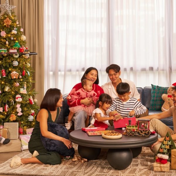 Family at Christmas time next to a decorated Christmas tree