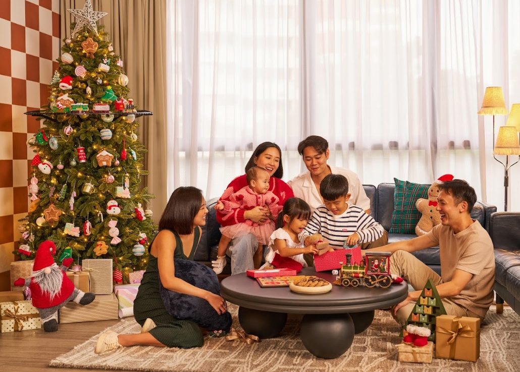 Family at Christmas time next to a decorated Christmas tree