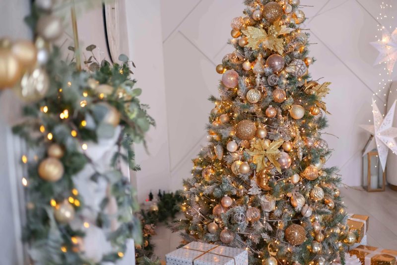 Snowy flocked Christmas tree with gold decorations